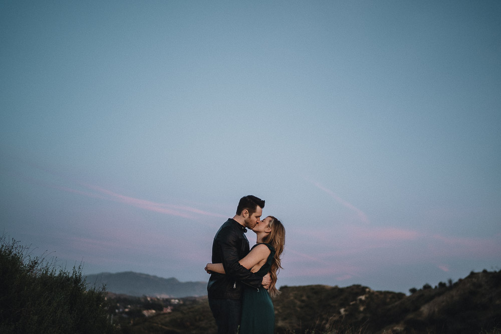 Couple hugging at blue hour during engagement session in los angeles canyon