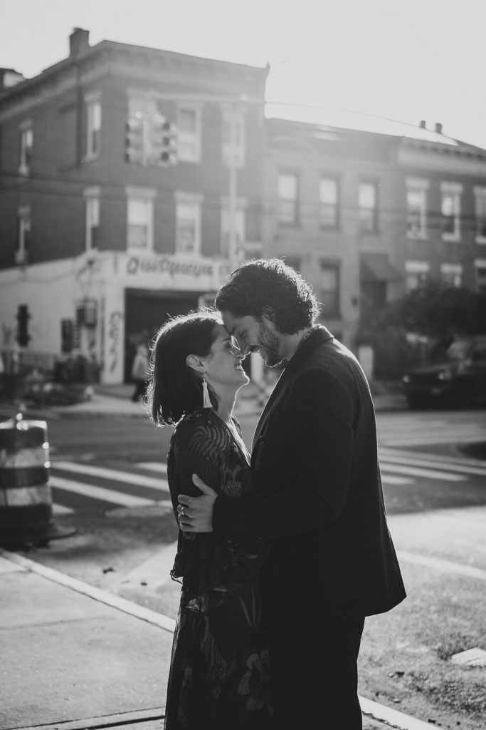 Couple snuggling in brooklyn at sunrise during elopement