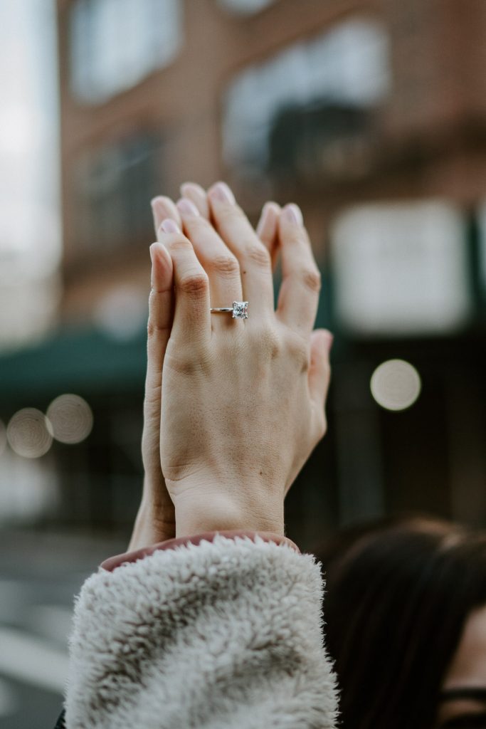 Close up of engagement ring on hand during engagement session in nyc