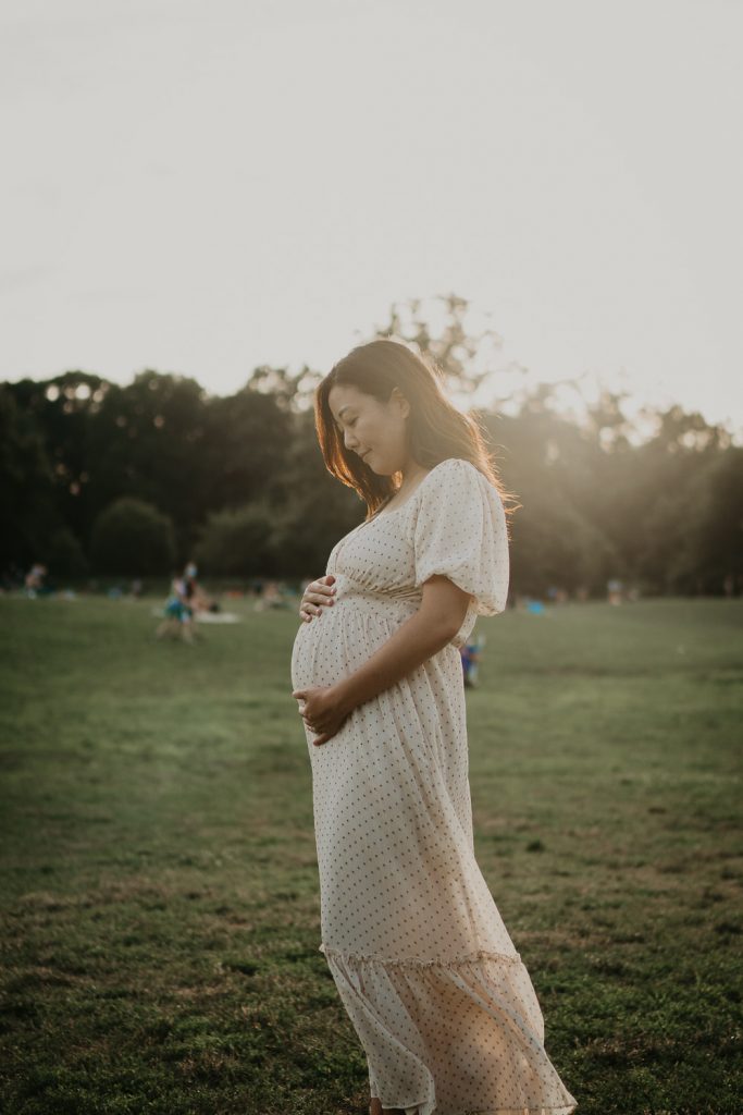 Pregnant woman in prospect park at golden hour during maternity session