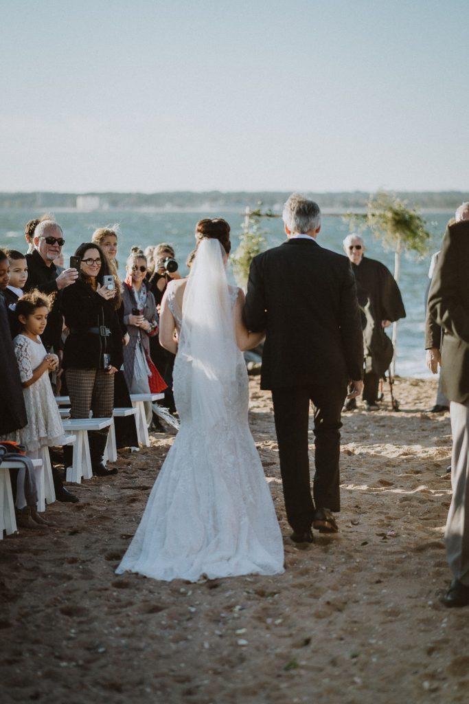 Bride and dad walk down the aisle at long island beach wedding