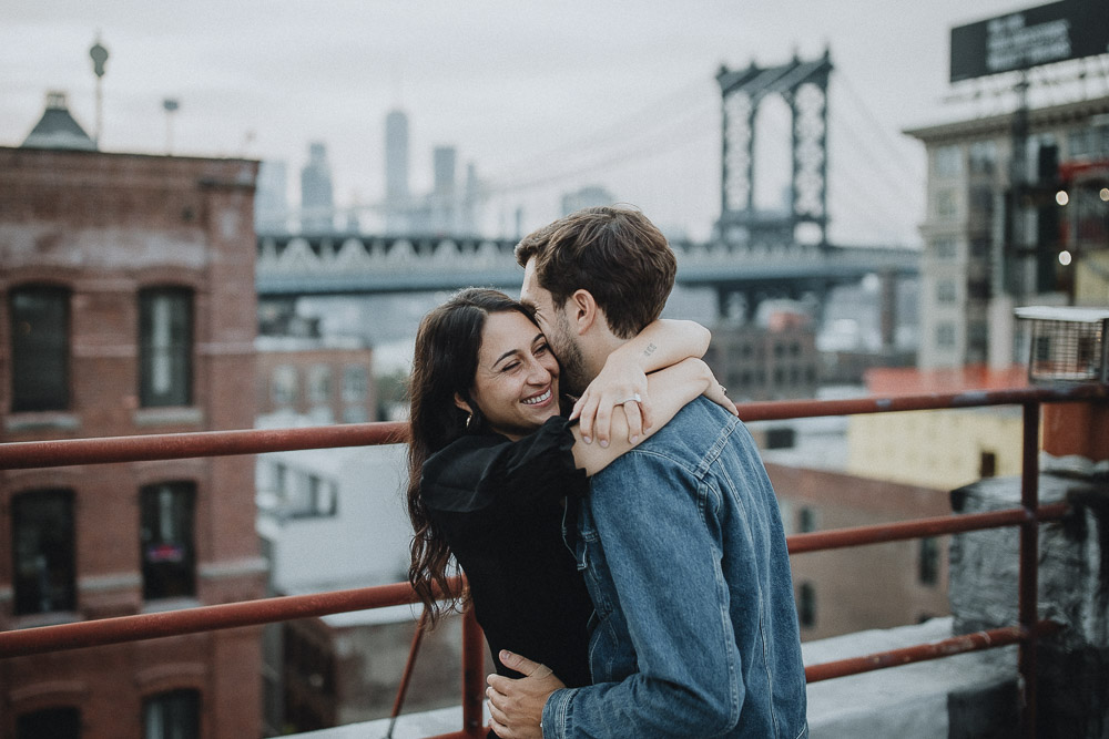 Couple on dumbo rooftop during brooklyn engagement session