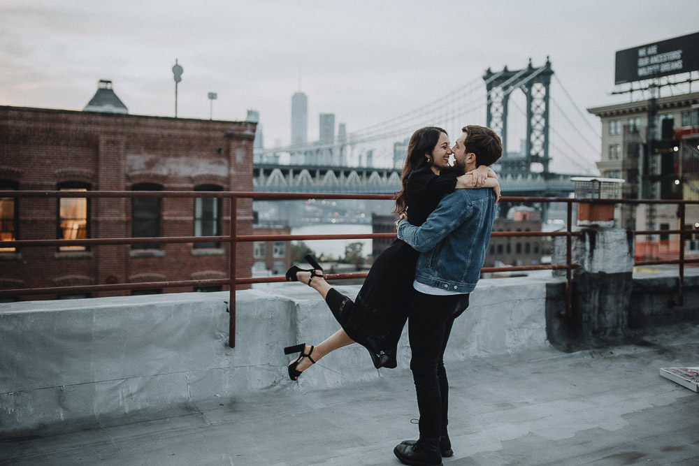 Couple on dumbo rooftop during brooklyn engagement session