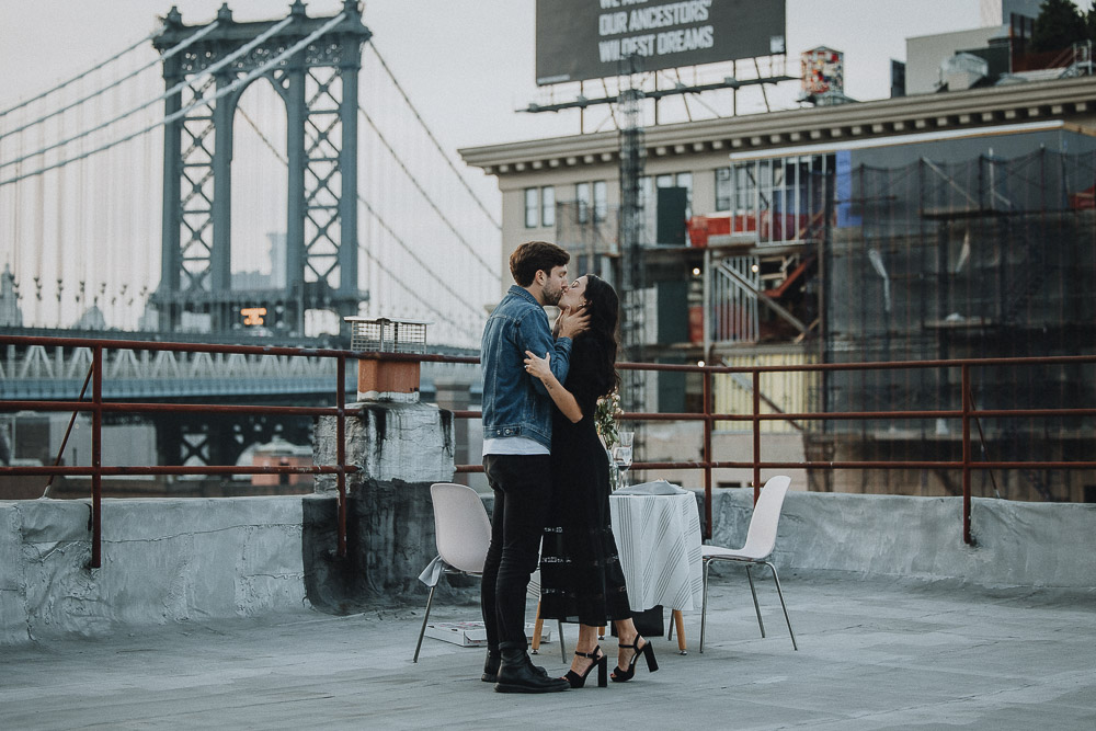 Couple on dumbo rooftop during brooklyn proposal