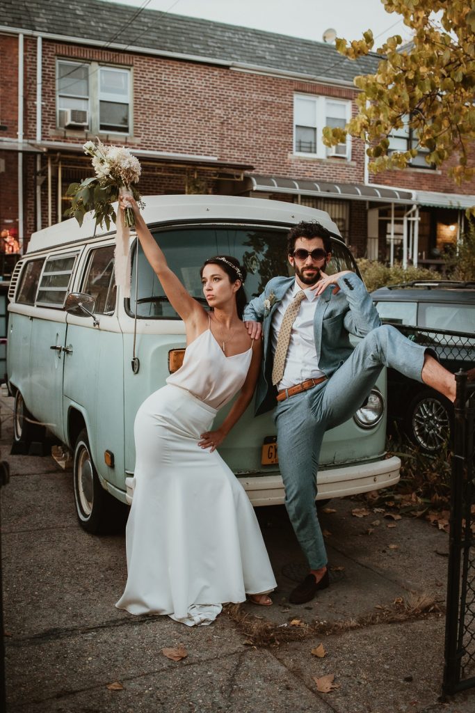 Bride and groom by old minivan at fall brooklyn wedding