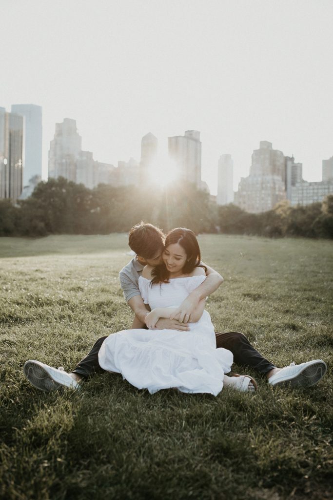 Expecting couple in central park at golden hour during maternity photoshoot