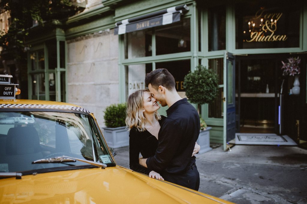 Couple by old taxi cab during nyc engagement photoshoot
