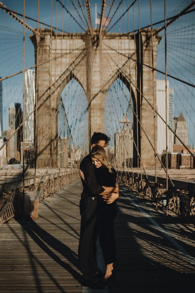 Couple on brooklyn bridge at sunrise during elopement photoshoot