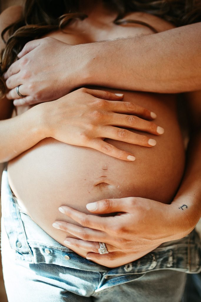 Belly close up during intimate maternity session in nyc home