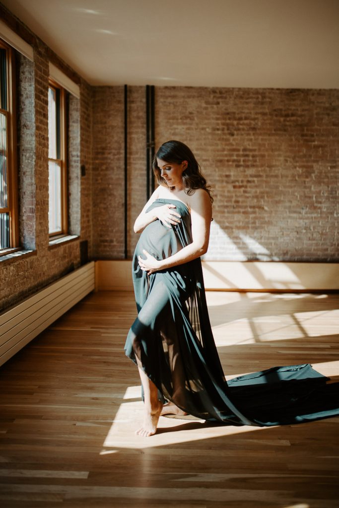 Naked pregnant woman during maternity session in nyc home