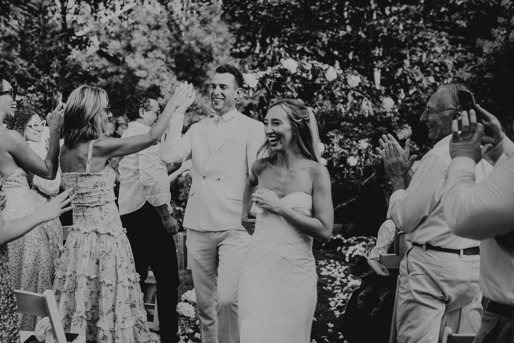 Bride and groom recessional at hamptons backyard wedding