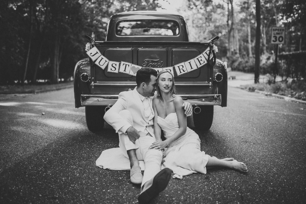 Bride and groom in vintage Ford truck at hamptons wedding