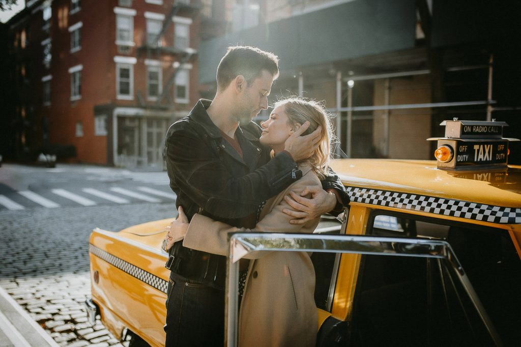 Couple by vintage taxi cab during nyc engagement photoshoot