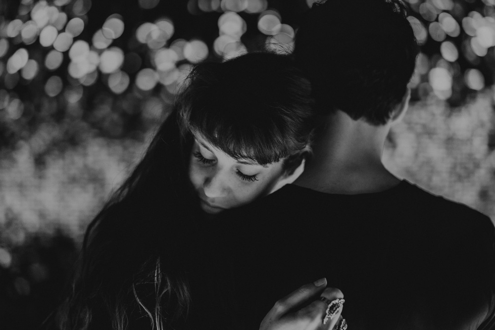 Woman holds her fiancé close and closes her eyes