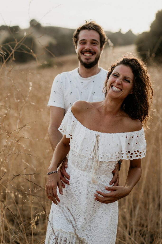 Boho bride and groom laugh in field during los angeles elopement
