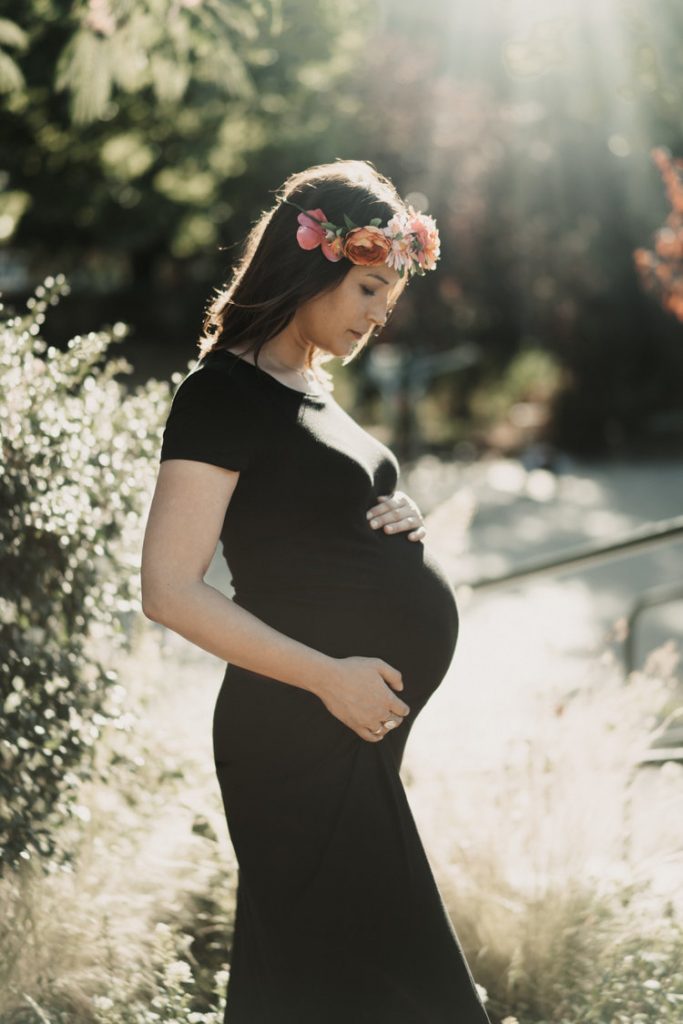 Pregnant woman with flower crown during outdoor maternity session in brooklyn