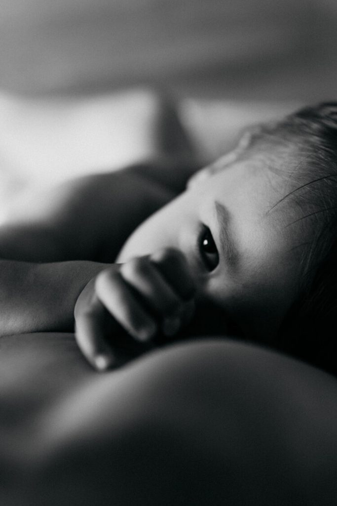 Baby breastfeeding mom during in home family session in brooklyn