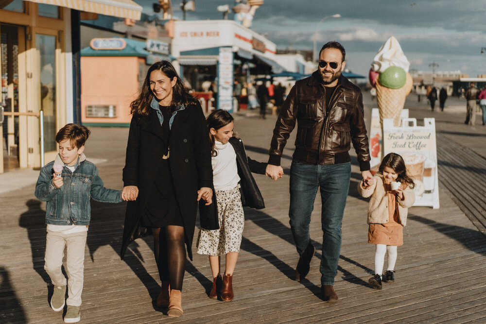 Parents and three kids during family session at coney island boardwalk