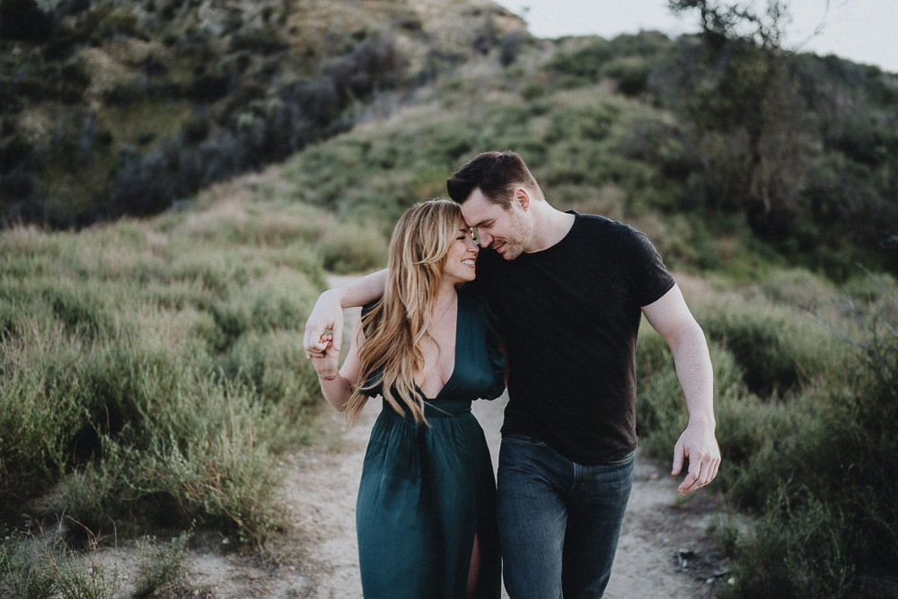Couple snuggles during engagement session in los angeles canyon