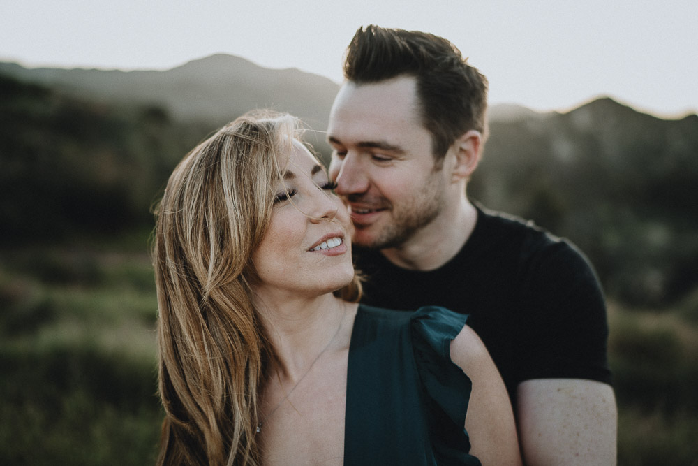 Man snuggles fiancée during engagement session in los angeles canyon