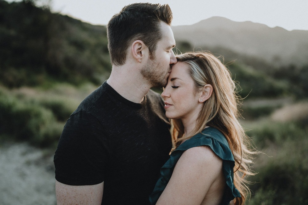 Man kisses fiancée's forehead during engagement session in los angeles canyon