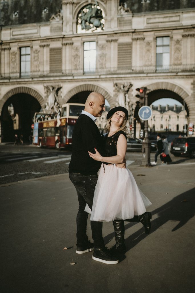 Couple dancing by le louvre during paris engagement session