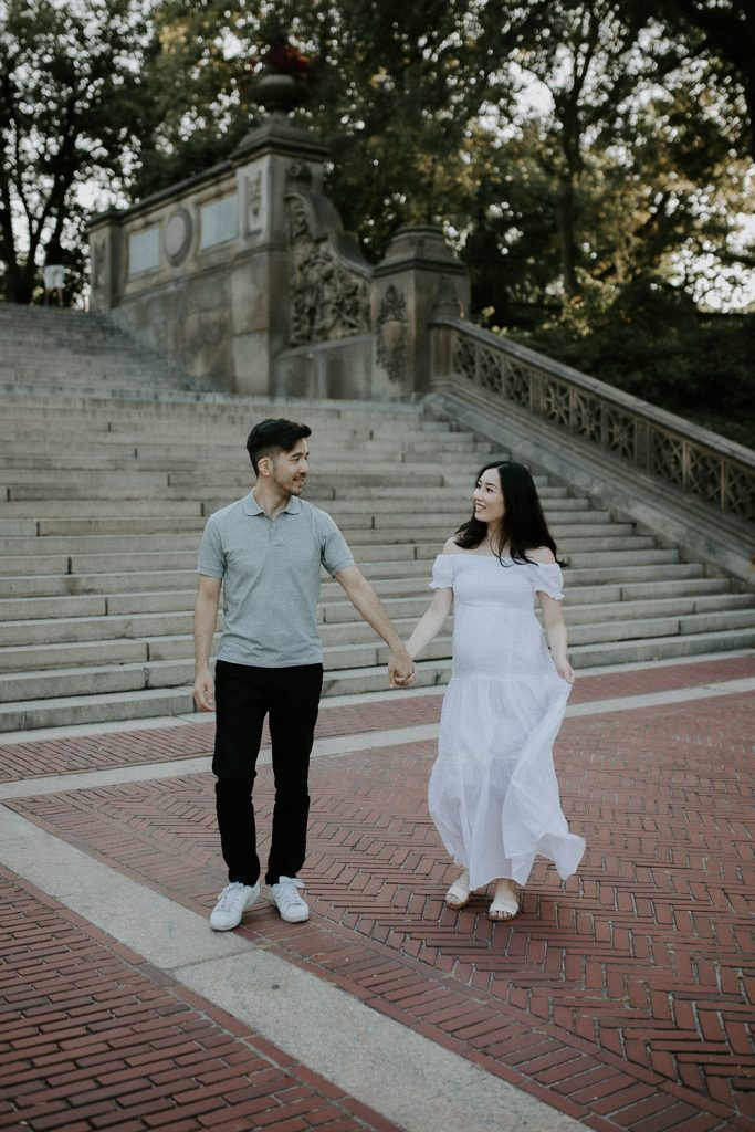 Expecting couple in central park at bethesda terrace during maternity photoshoot