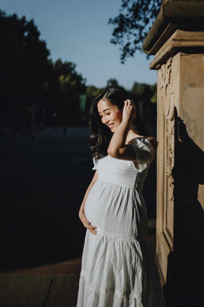 Pregnant woman in central park at bethesda terrace during maternity photoshoot