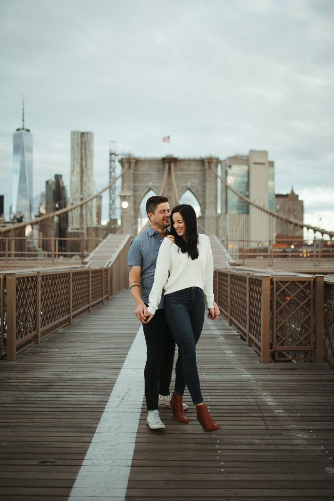 Couple during engagement session on the brooklyn bridge