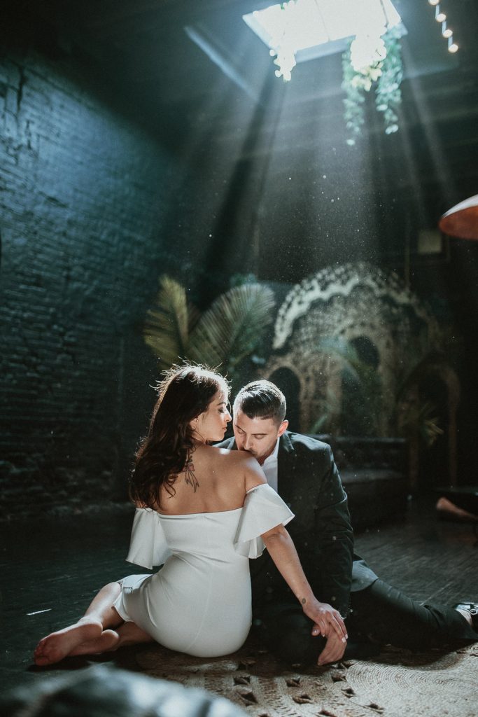 Bride and groom's backlit portrait at industrial chic wedding in brooklyn