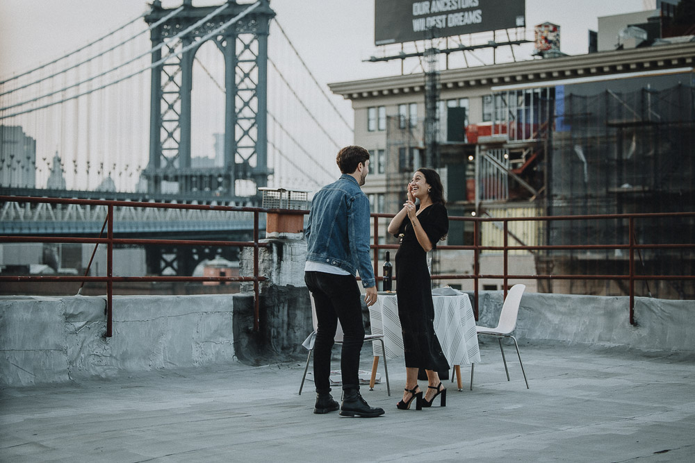 Couple on dumbo rooftop during brooklyn proposal