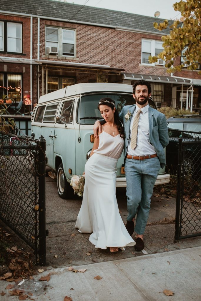 Bride and groom by old minivan at fall brooklyn wedding
