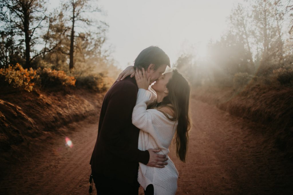 Couple kissing during sedona elopement at golden hour