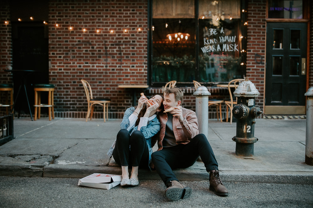 Couple eats pizza during engagement shoot in the west village of nyc
