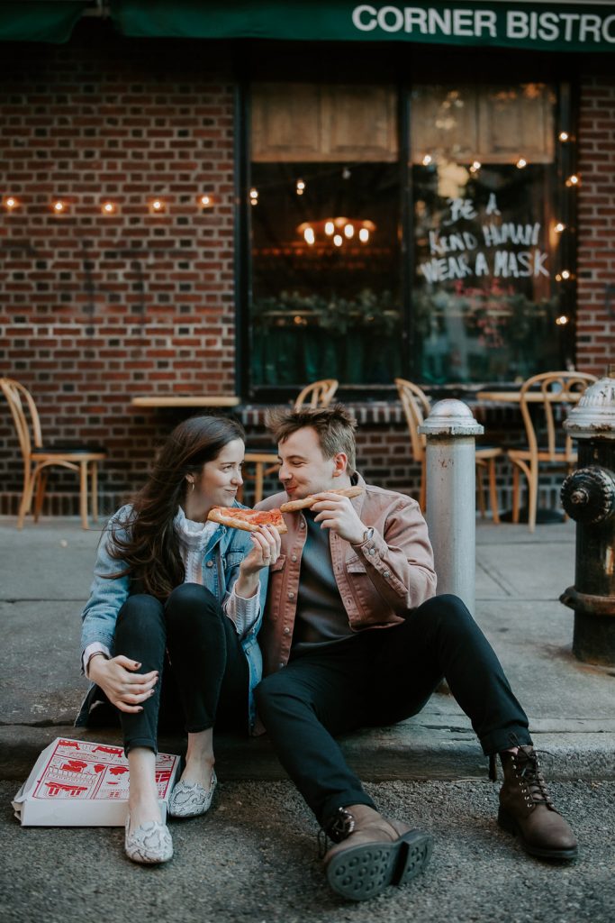 Couple eats pizza during engagement shoot in the west village of nyc
