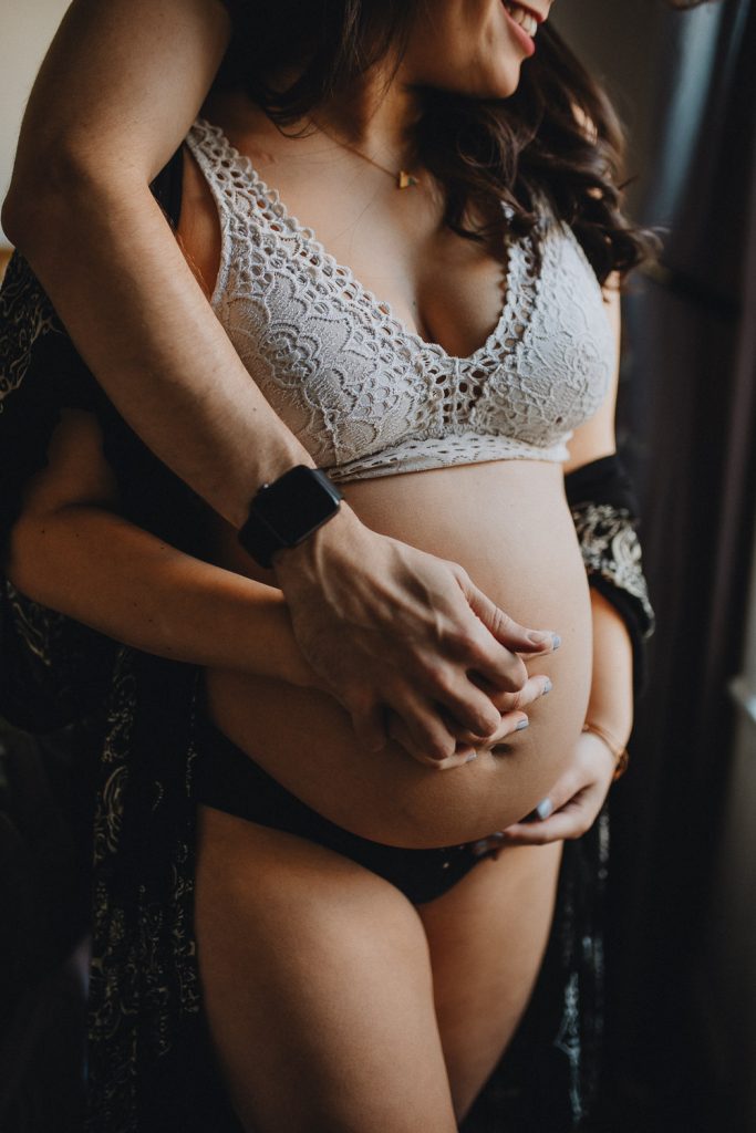 Expecting couple during maternity photoshoot at home in brooklyn