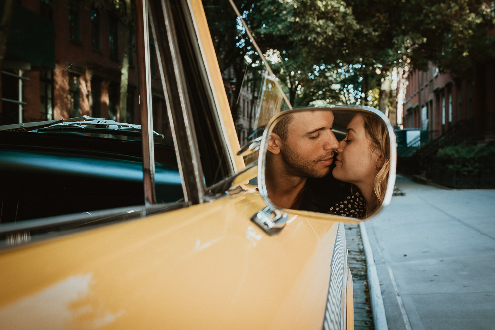 Couple in old taxi cab during nyc engagement photoshoot