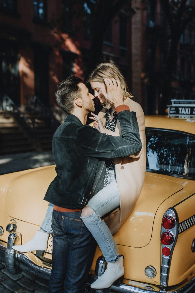 Couple by old taxi cab during nyc engagement photoshoot