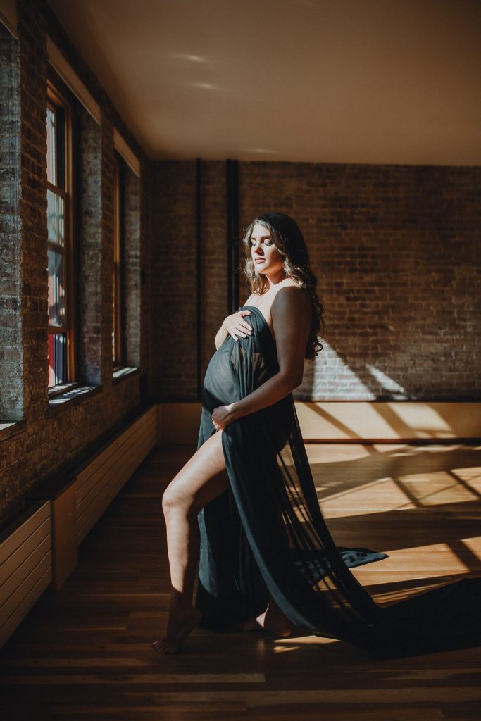 Naked pregnant woman during maternity session in nyc home
