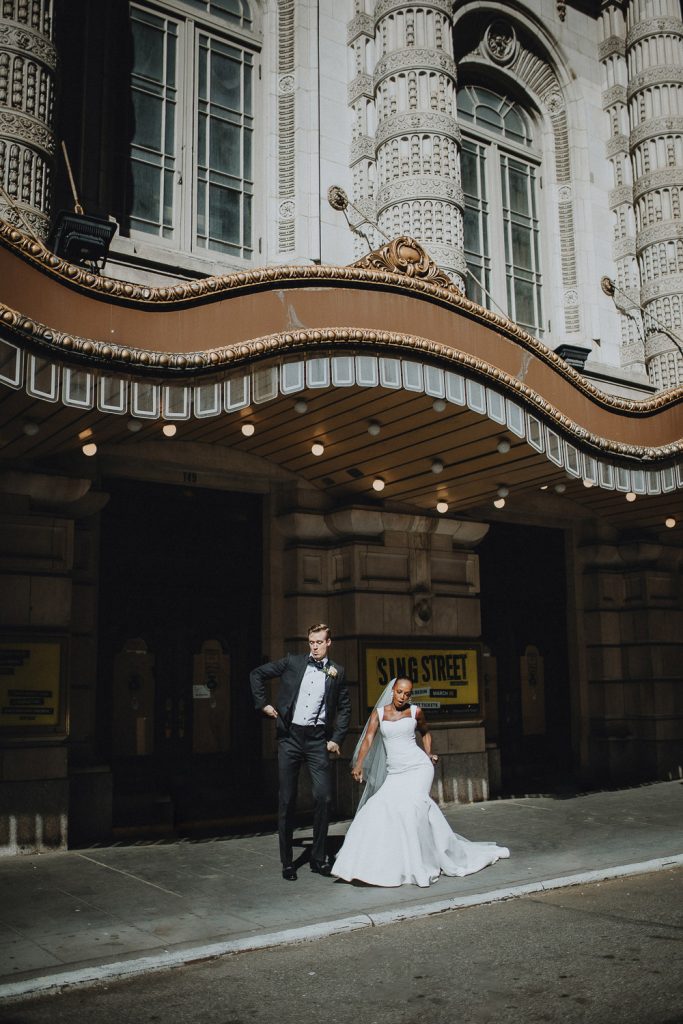 Interracial bride and groom being goofy on wedding day in nyc