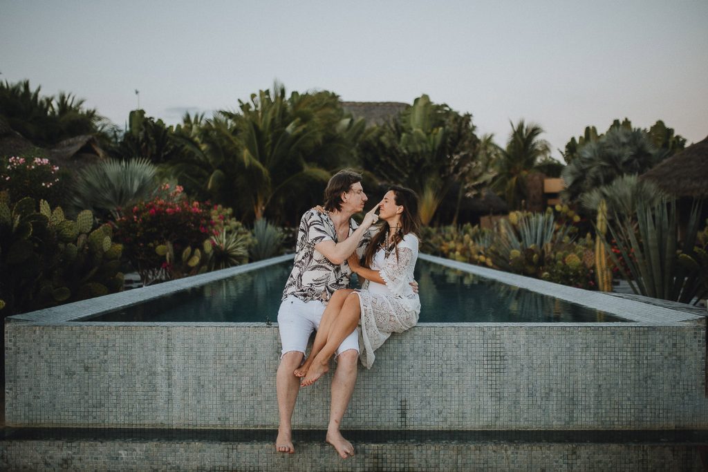 Couple by pool during destination elopement in tulum