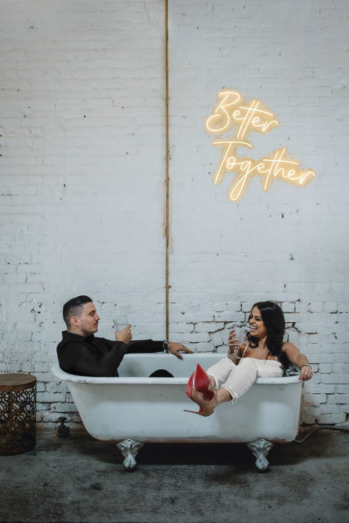 Bride and groom in bathtub at brooklyn warehouse wedding