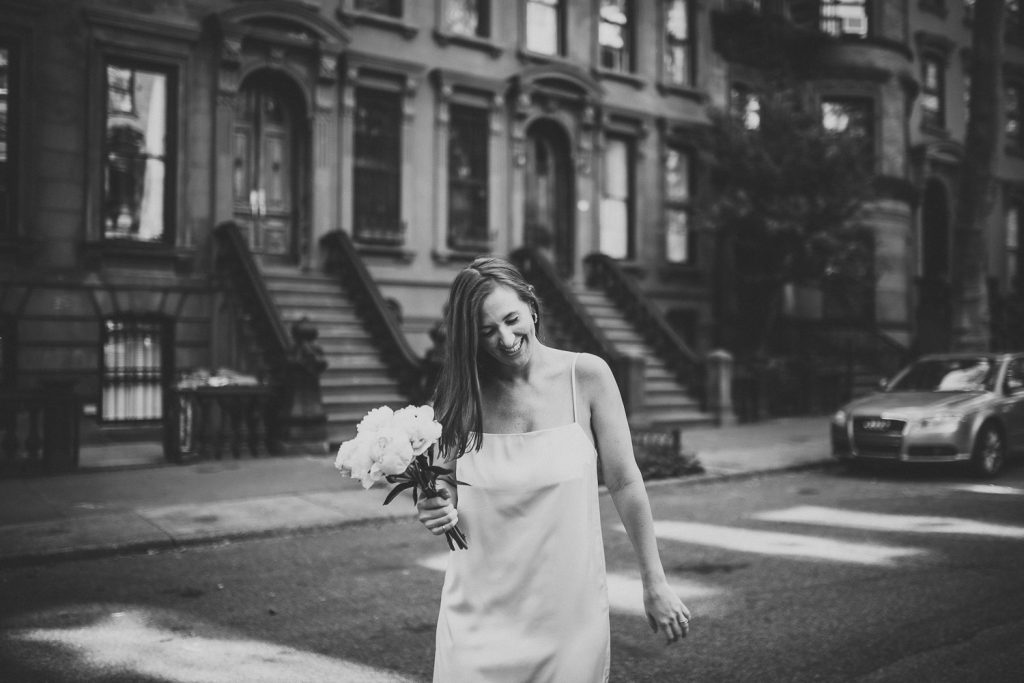 Bride by brownstone at intimate wedding in fort greene brooklyn