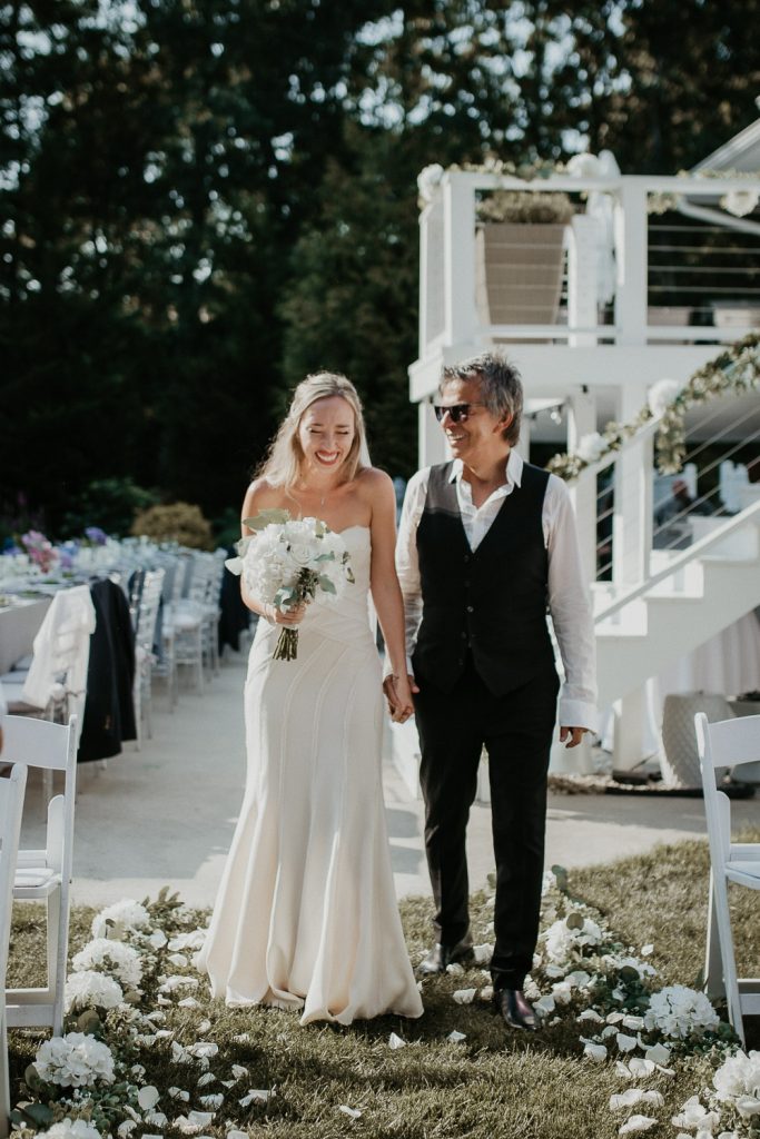 Bride walks down the aisle at backyard wedding in the hamptons