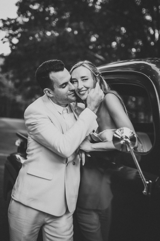 Bride and groom in vintage Ford truck at hamptons wedding