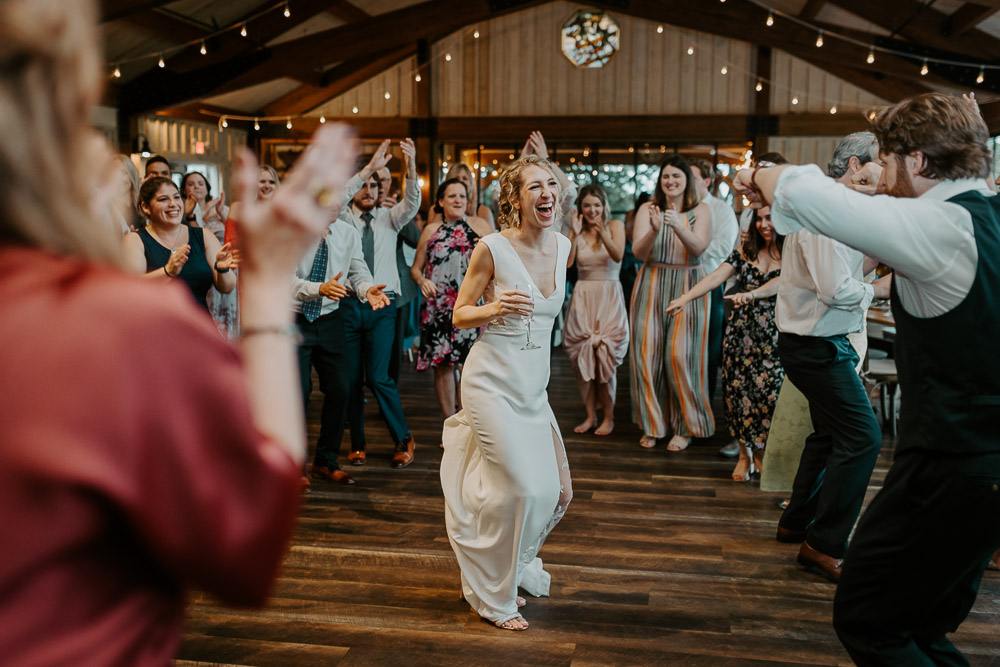 Bride dancing at red maple vineyard wedding reception