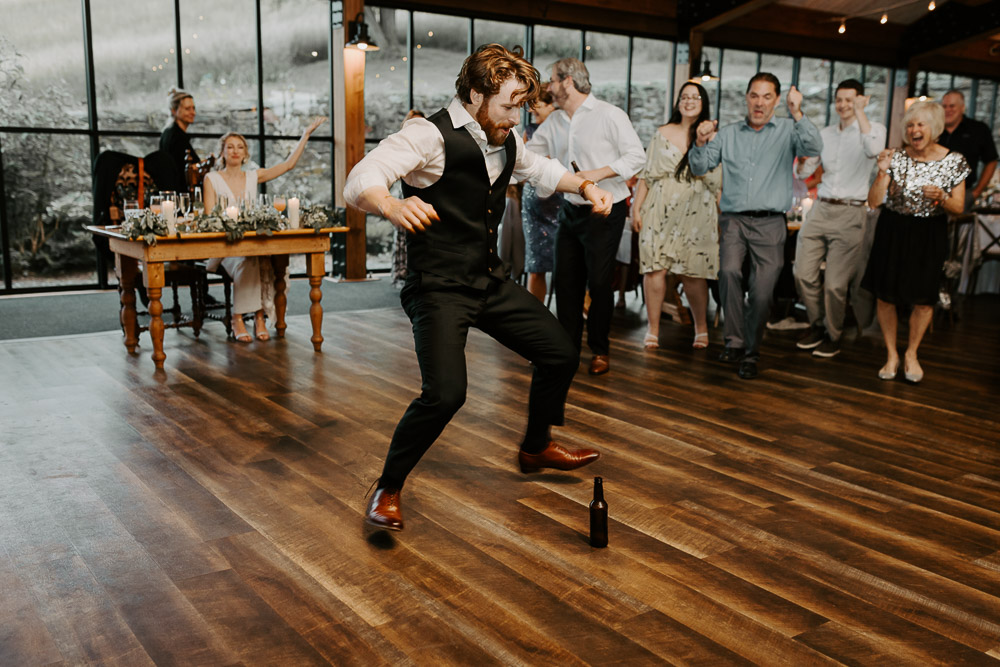 Groom dancing at red maple vineyard wedding reception