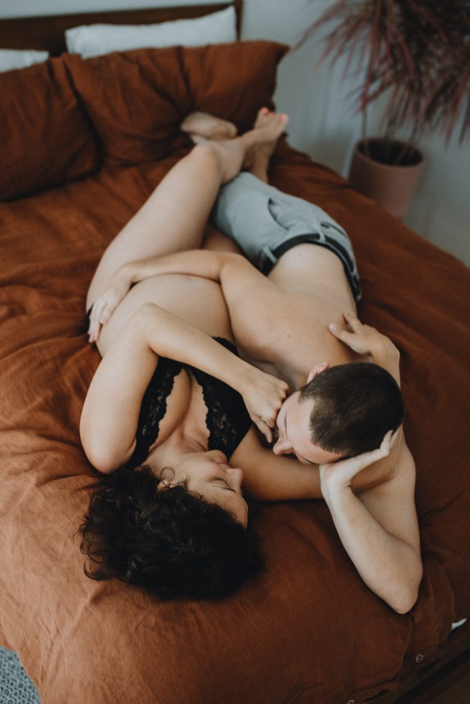 Expecting couple during intimate maternity session in nyc home