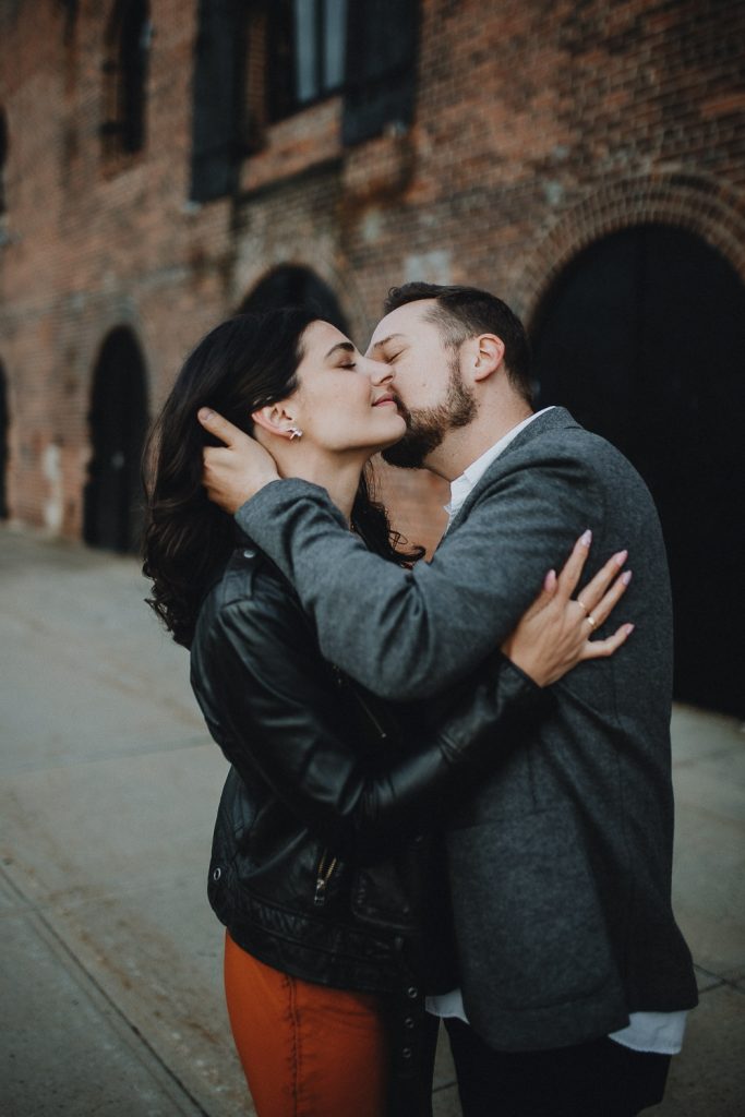 Couple taking engagement photos in brooklyn red hook
