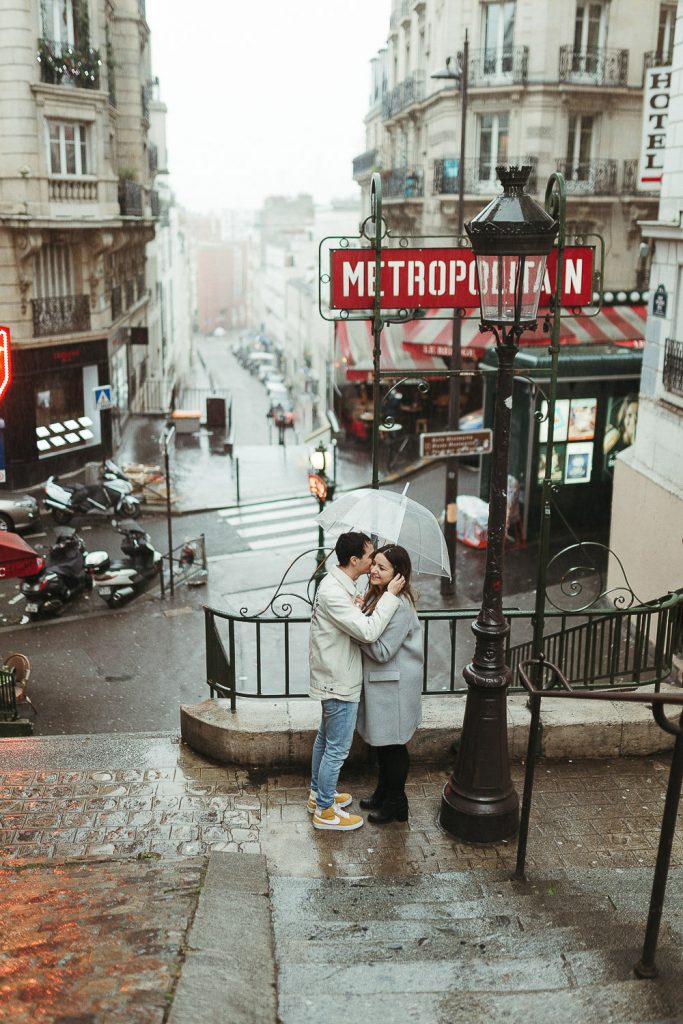 Couple in paris montmartre during rainy elopement photoshoot